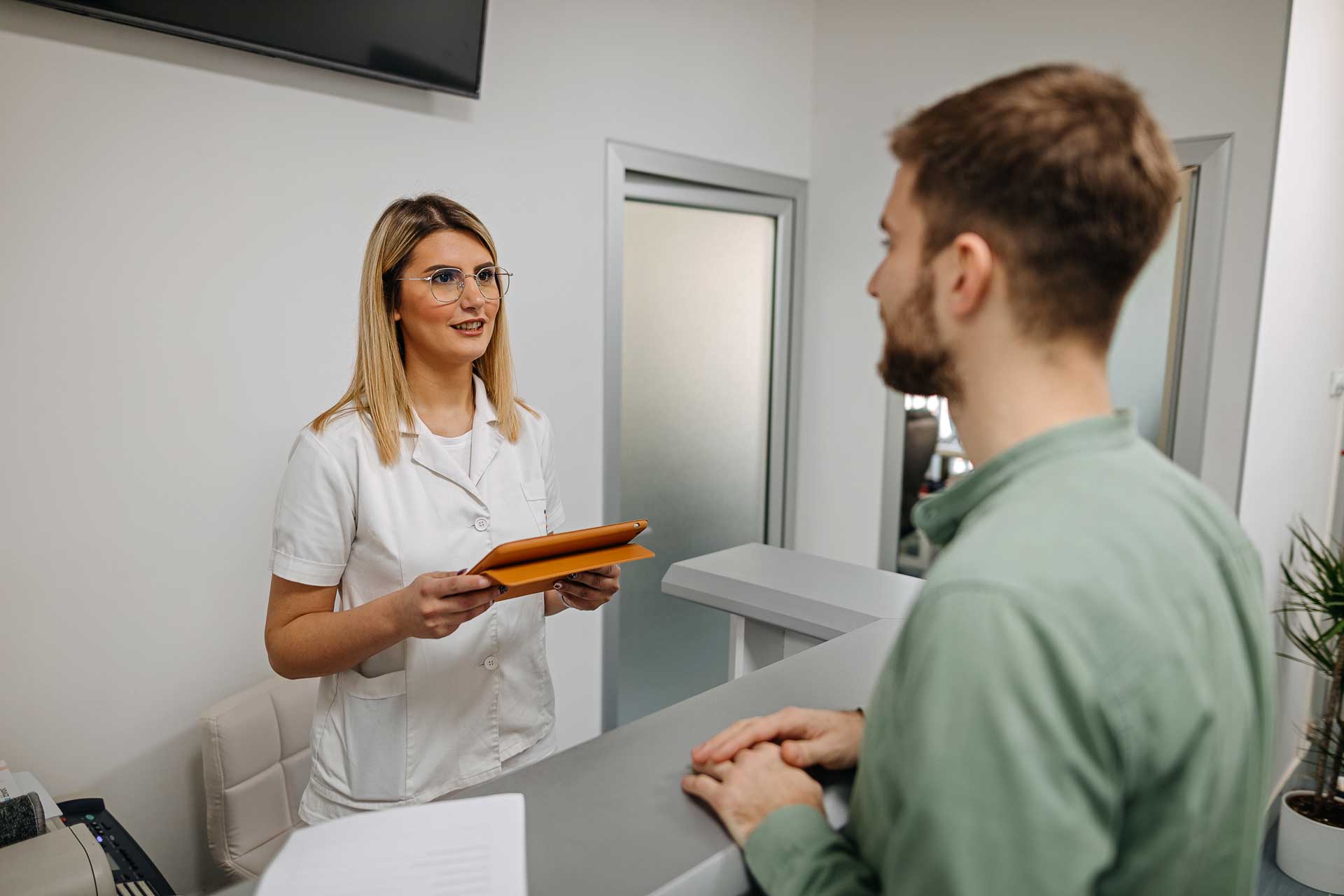 receptionist helping a patient using sentact technology