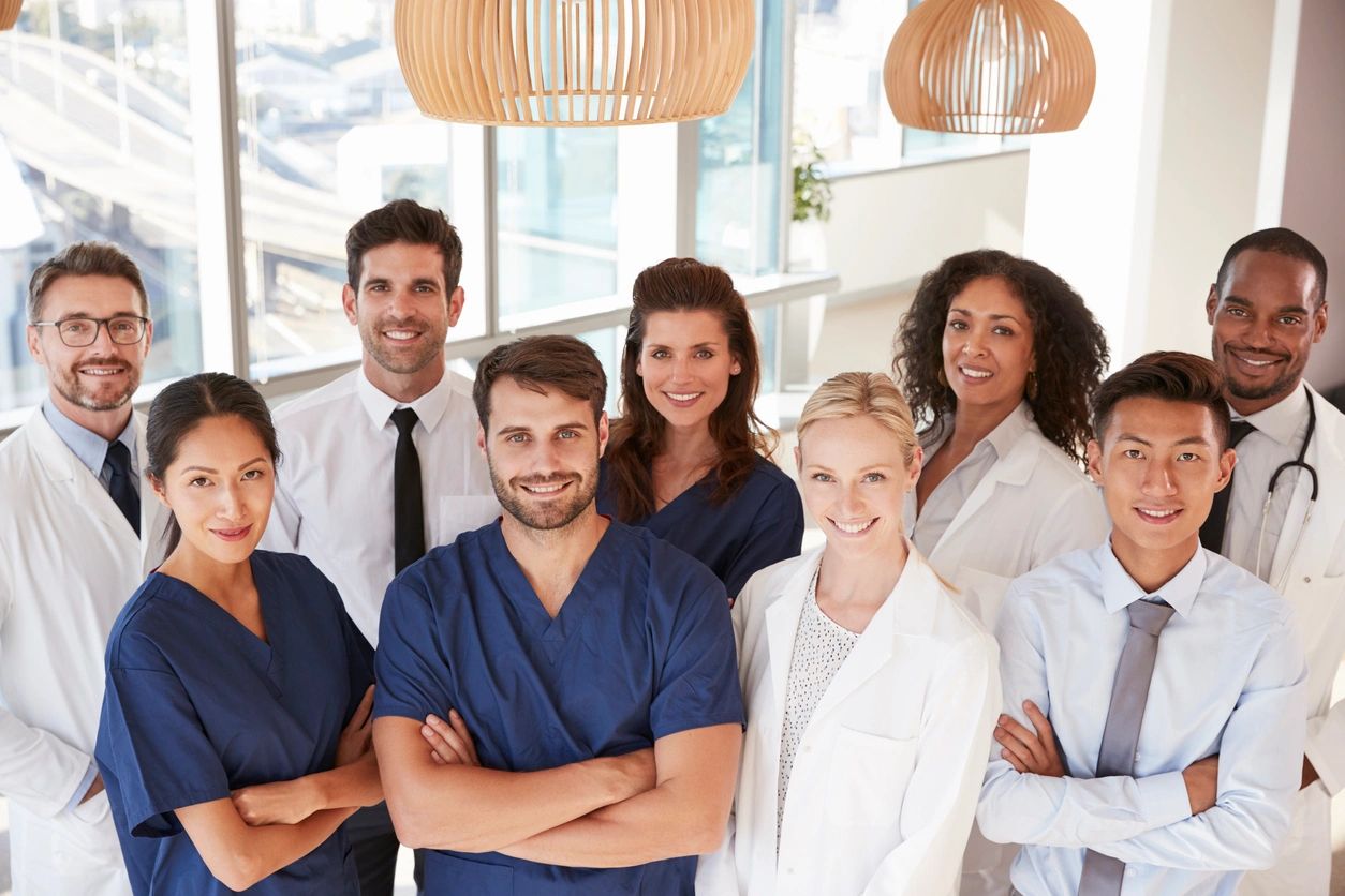 Group of doctors and physicians smiling and posing for a photo